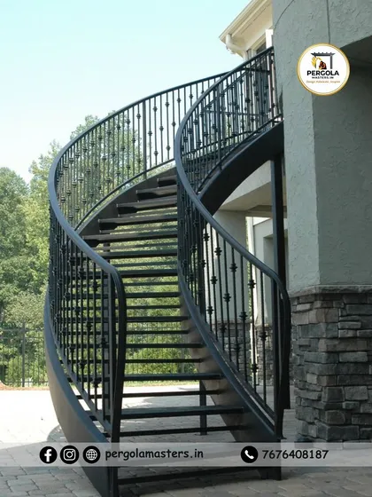 An elegant, free-standing curved metal staircase designed for an exterior space. The smooth curves and detailed balusters demonstrate our precision fabrication skills, creating a timeless architectural feature that adds grace and value to the property.