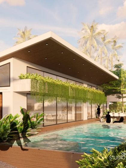 A view of the infinity pool and deck at the Pai Residence, with hanging creepers creating a green curtain along the facade. This biophilic element adds privacy and texture, enhancing the connection between the architecture and the landscape.