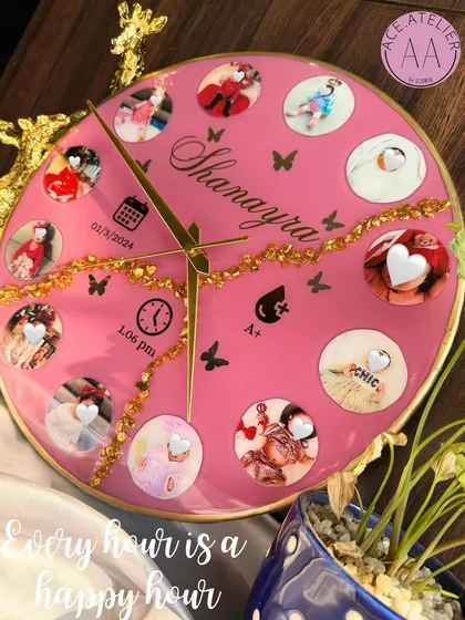Celebrate every precious moment with a custom baby clock. This bright pink resin clock features twelve photos from baby Shanayra's first year, along with her birth details, making it a perfect centerpiece for a nursery.