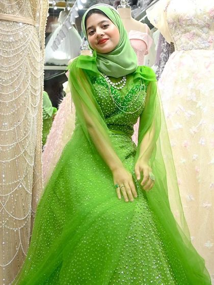 A picture of grace and sophistication. This bright green gown, paired with a matching hijab and pearl necklace, is a complete look for any special occasion.