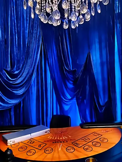 A close-up of the custom poker table under a magnificent crystal chandelier, ready for a high-stakes evening.