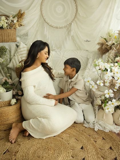 A sweet conversation between a mother and her son about the new baby. This candid moment is a precious part of any family maternity session.