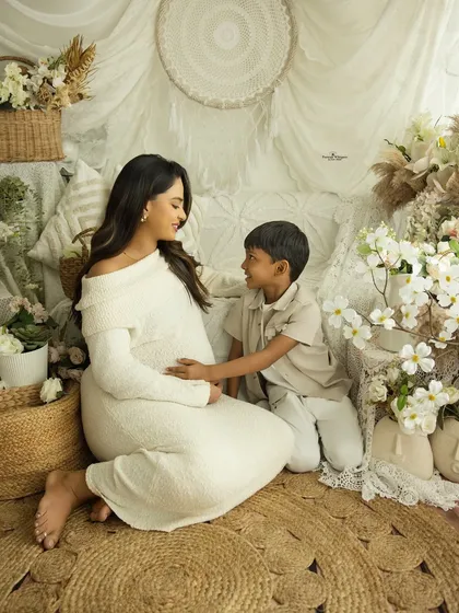 A conversation between a mother and her firstborn. This gentle, seated portrait captures the special bond they share as they talk about the new baby on the way.