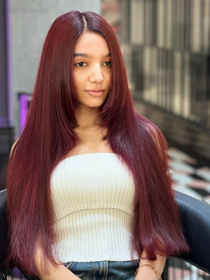 Turning heads with every red strand. This vibrant red is sleek, shiny, and full of confidence.