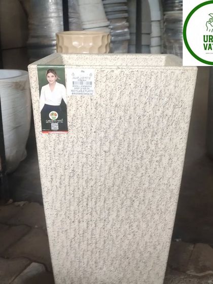 A tall, white, textured fiber pot.