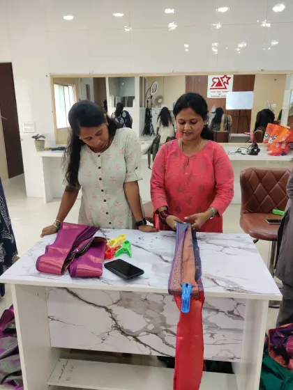 Two students working together during a practical session. I encourage a supportive environment where everyone learns from each other while mastering the art of saree pleating.