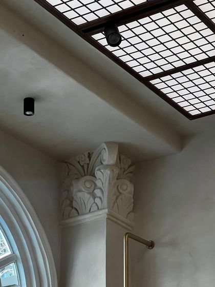 A detail of the ornate, restored column capital inside the Eka store. We chose to preserve and highlight the original architectural features of the heritage building, integrating them into the contemporary retail design.