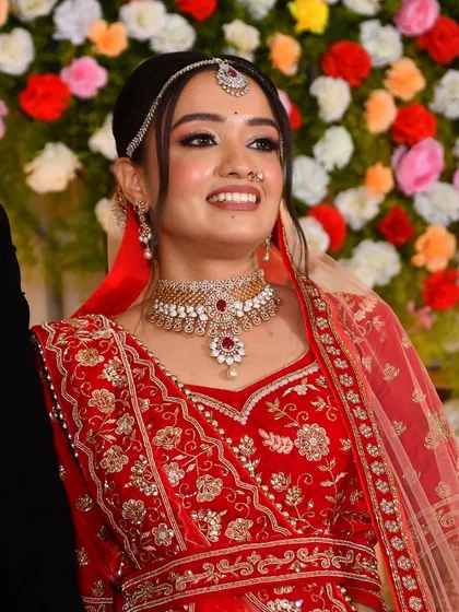 A candid shot from the wedding ceremony, her smile lighting up the frame.