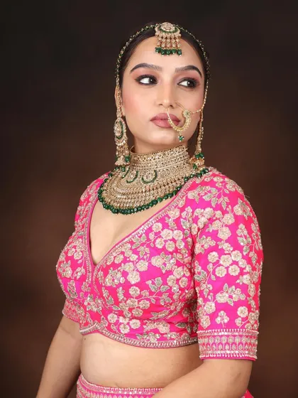 A side profile showcasing the beautiful hair and makeup. The focus is on clean lines, a glowing cheek, and how the nath (nose ring) sits perfectly.