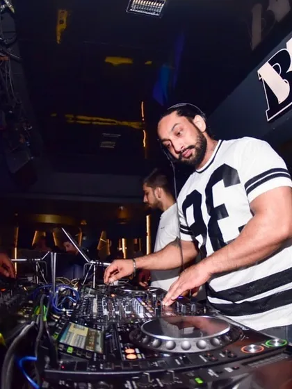 In the middle of a mix, focused on the decks. I take pride in the technical side of my craft, ensuring smooth transitions all night.