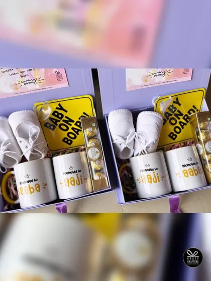 A side-by-side view of two identical pregnancy announcement hampers, perfect for surprising both sets of grandparents at the same time.