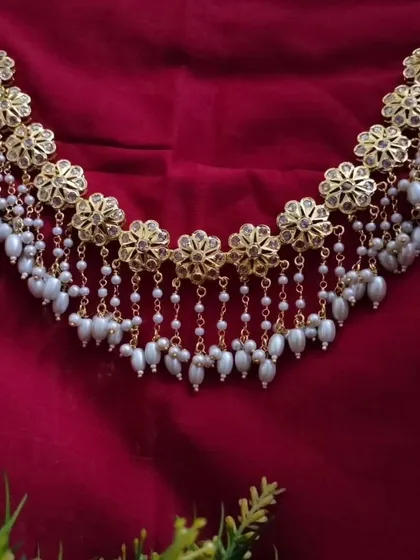 The 'उज्वला' (Ujwala) Hyderabadi necklace, featuring floral motifs and cascading pearl chains. This piece has a beautiful, traditional charm that is both grand and graceful.