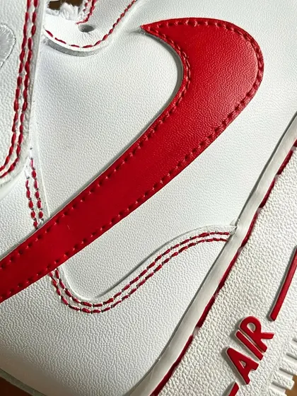 A close-up of the vibrant red Nike swoosh and the faux-stitch detailing.
