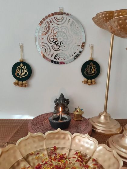 This set of Ganpati wall hangings is in a beautiful dark green, decorated with golden beads. They make a wonderful housewarming or Diwali gift.