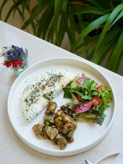 Our egg white omelette with spinach and mushrooms is a popular choice for a healthy and delicious breakfast, served with a side of fresh salad greens.