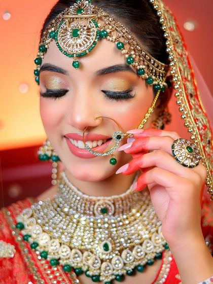 A close-up focusing on the bride's happy expression and the details of her nath and necklace.