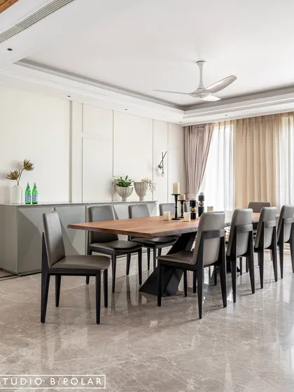 The dining room at Noor Haus is spacious and bright, with a large wood table and comfortable leather chairs. The design is minimal yet warm, perfect for both family meals and formal entertaining.
