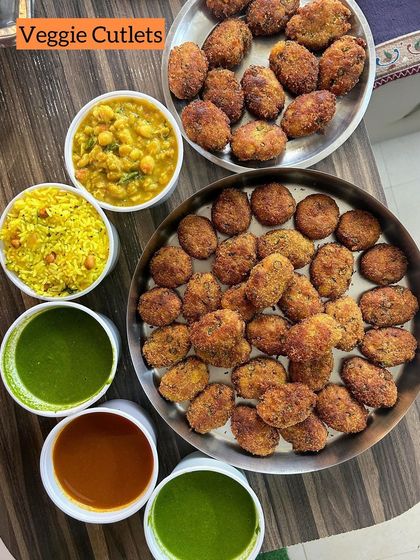 A platter of crispy Veggie Cutlets served with chutneys, chole, and poha. A hearty and delicious snack option.