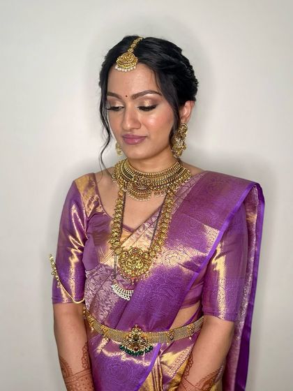 This three-quarter profile highlights the contouring and highlight that sculpts the face, along with the soft updo that is perfect for securing the bridal veil and jewellery.