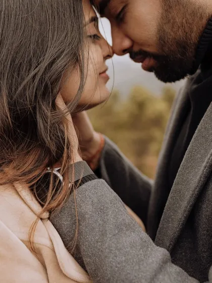 An intensely emotional and intimate close-up. This shot captures the profound connection and tenderness between the couple, framed by the soft, natural light.