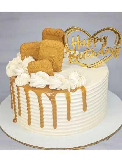 A delectable Lotus Biscoff cake. This cake is simply decorated with a Biscoff drip, piped cream, and the iconic crunchy biscuits.