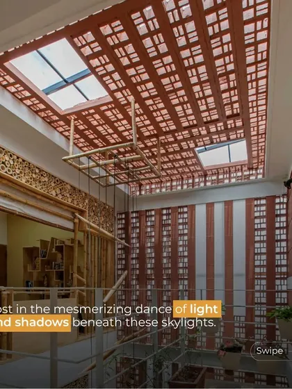 A view of a mezzanine level illuminated by skylights set into a ceiling with exposed terracotta filler slabs. This combination of techniques creates a space that is both structurally efficient and aesthetically warm.