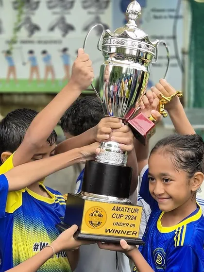 Lifting the trophy high. A moment of shared success for our U9 team.