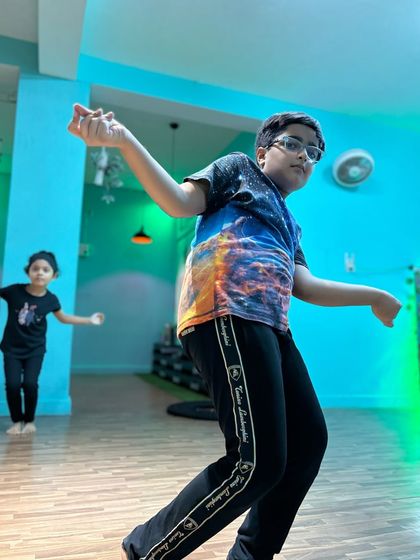 A student from our Powerpuff Intermediate class, captured mid-move. The energy and passion for dance are clear in his expression.