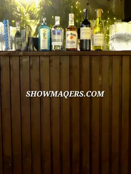 A well-stocked and stylish bar is essential for any gala. This rustic wooden bar, backlit with warm fairy lights, provided a central point for guests to mingle and enjoy refreshments.