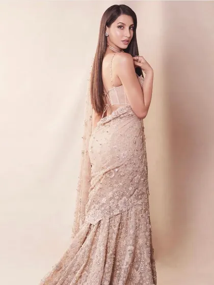For this look, I dressed Nora Fatehi in a magnificent embroidered saree by Tarun Tahiliani. The intricate detailing and corset-style blouse offer a fresh and glamorous take on classic Indian attire.
