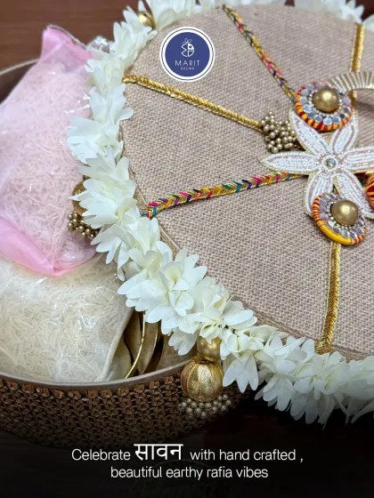 Celebrate 'Sawan' with handcrafted, earthy 'rafia' vibes. This hamper includes a beautifully decorated 'mithai' box and other festive treats, all packed in a rustic and elegant style.