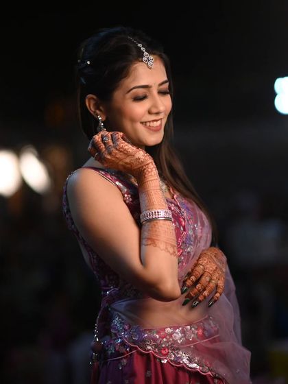 A stunning look for a wedding guest. The makeup is soft and shimmery, with a focus on the eyes, and her smile shows she's ready to celebrate.