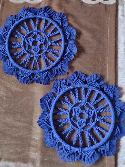 A pair of twin macrame mandalas in a deep blue. These are perfect for creating a symmetrical and balanced look on a gallery wall or on either side of a piece of furniture.