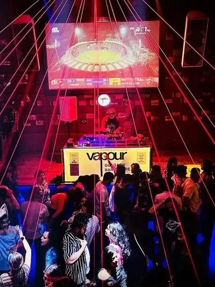 A view from my console during a peak-hour set. The combination of laser lights and a packed dance floor creates a visual spectacle that matches the intensity of the music.