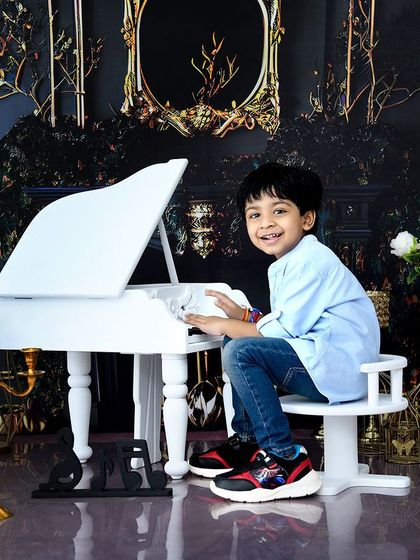 Even older kids love the piano theme! It's a sophisticated and fun setup for capturing beautiful portraits at any age.