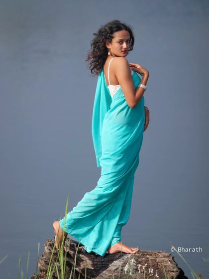 A graceful and elegant pose, this portrait by the water has a timeless, classic feel.