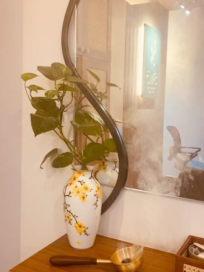 The reflection of our salon in the mirror, showing the calm and order we strive to maintain. The gentle steam in the background is from our traditional Sambrani hair drying ritual.