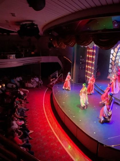 The onboard entertainment on the Cordelia cruise, showing a dance performance in the ship's theater.