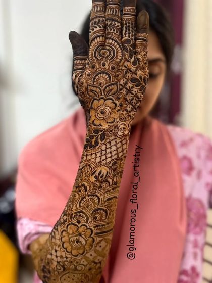 Another view of the cascading floral design, with the client holding her hand up to display the full artwork.