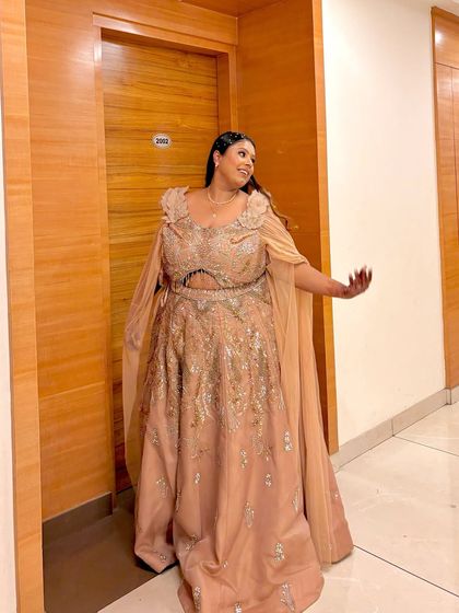Another shot of the plus-size client in her fairytale gown. The flowing cape adds a touch of drama and elegance.