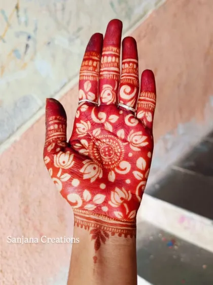 The magical moment when the henna stain is revealed. This is the beautiful, rich red colour of the cutwork design after the paste is removed.