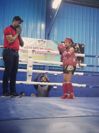 Showing respect to a young fighter after her performance. This is a core part of Muay Thai, honoring your opponent and the sport itself.