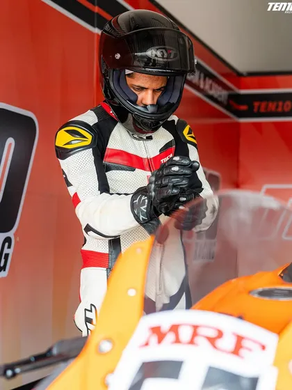 Preparation is everything. A rider gets into the zone, adjusting his gear in the pit box before heading out. Every detail matters when you are competing at the highest level.