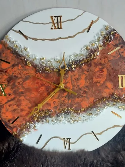 A close-up of the fiery orange and brown geode clock, showing the rich colors and textures.