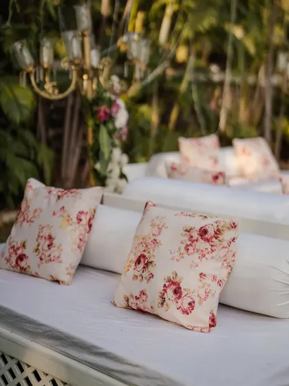 Comfort and style go hand in hand. For this outdoor event, we arranged for low, comfortable diwan-style seating with floral cushions, allowing guests to relax and mingle in a chic, laid-back setting.