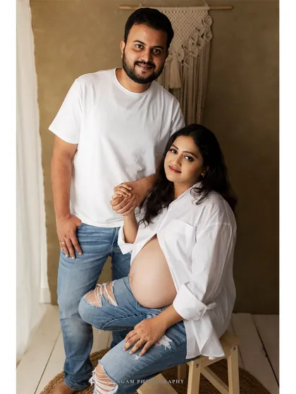 A sweet and classic couple's pose, their coordinated casual outfits creating a look that is both stylish and timeless.