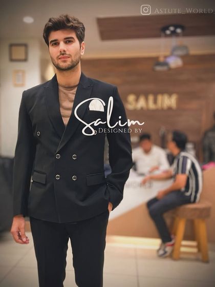 A client in a classic black double-breasted suit. This timeless piece is a staple in any gentleman's wardrobe, and I ensure it's tailored to perfection.