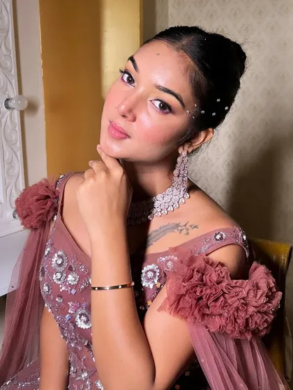 A radiant look from a recent campaign shoot. This style features a sleek bun with crystal details and a soft, glamorous makeup application.