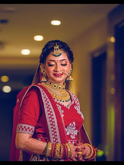 A stunning North Indian bride ready for her pheras. The look features a classic red lehenga, traditional jewellery, and makeup that highlights her beautiful features.
