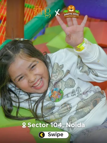A girl laughing with joy while playing in the foam pit. It's a safe and fun area for kids to jump and tumble.